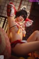 A woman in a red and white outfit is posing for a picture.