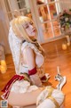 A woman in a wedding dress sitting on the floor.