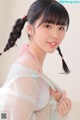 A woman with long black hair wearing a white dress.